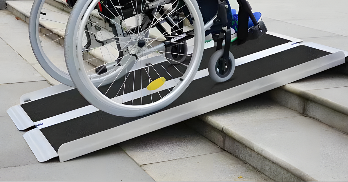 A wheelchair safely navigates over steps using a sturdy, portable ramp, demonstrating easy accessibility and mobility support.