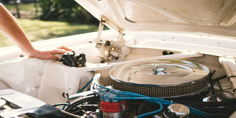 a person checking a car engine