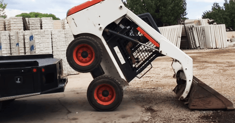 man-trying to-load-a-bobcat-to-a-ute-without-a-ramp