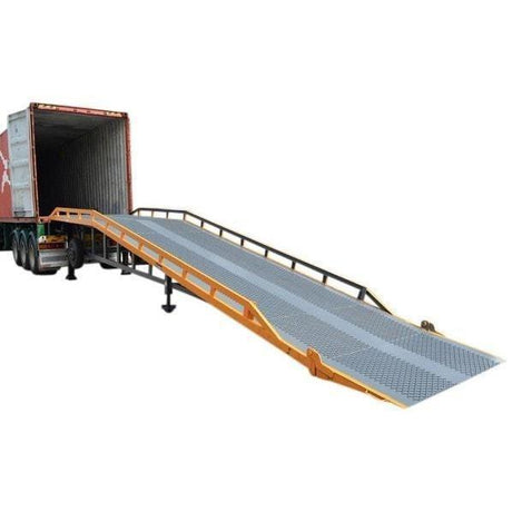 Yellow and grey steel yard ramp against a truck trailer