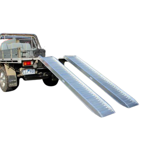 Pair of aluminium ramps against a ute