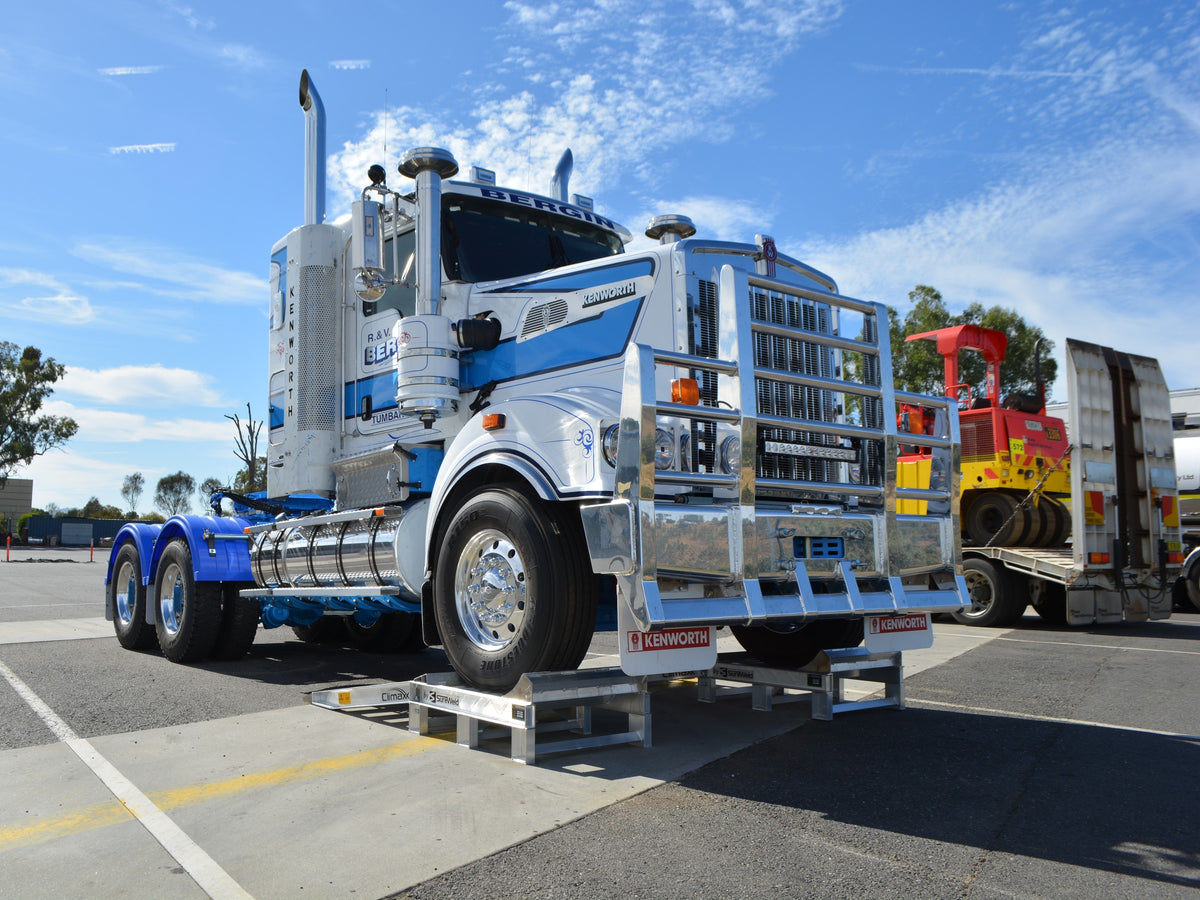 Kenworth prime mover with its front steer wheels raised on Sureweld truck wheel riser ramps