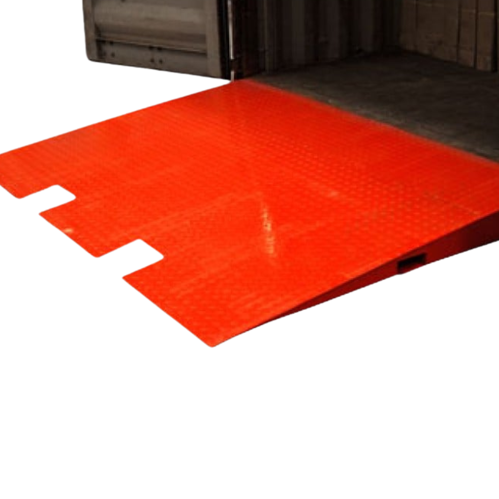 Side view of the ramp placed at a warehouse entry, showing low-profile incline and gritted surface texture.