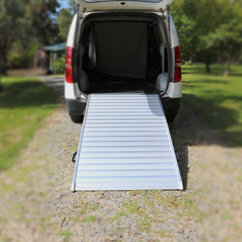 Rear van view with aluminium ramp set up for unloading.