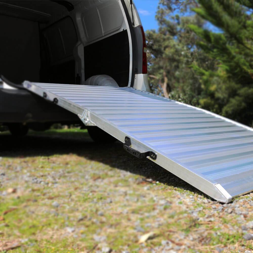 Ramp connecting to van over grass surface, suitable for outdoor use.