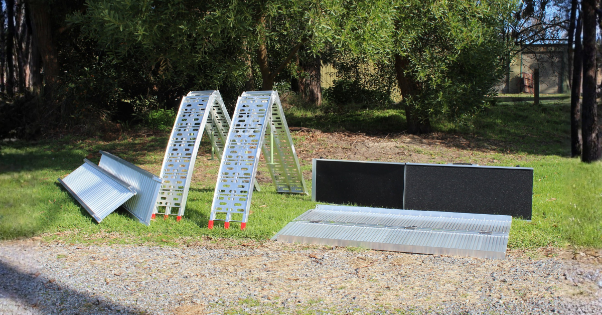 Metal ladders on grass with trees in the background