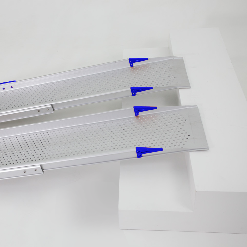 Close-up of two Heeve Aluminium Telescopic Mobility Ramps with perforated surfaces and blue securing brackets, placed on a set of steps, highlighting the ramp’s secure attachment points and anti-slip perforations for safe mobility assistance