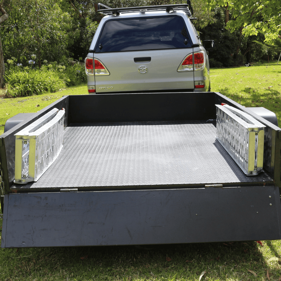 A loading ramp setup with a trailer, providing a practical example of its application for vehicle loading