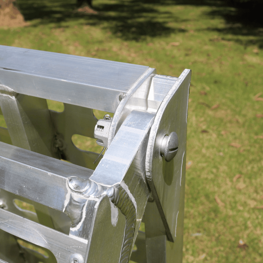 A close-up of the ramp’s hinges, demonstrating its sturdy construction and foldability.