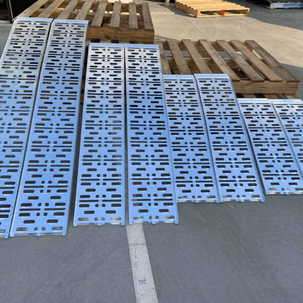 Four different-sized aluminium curved ramps displayed side by side on concrete.