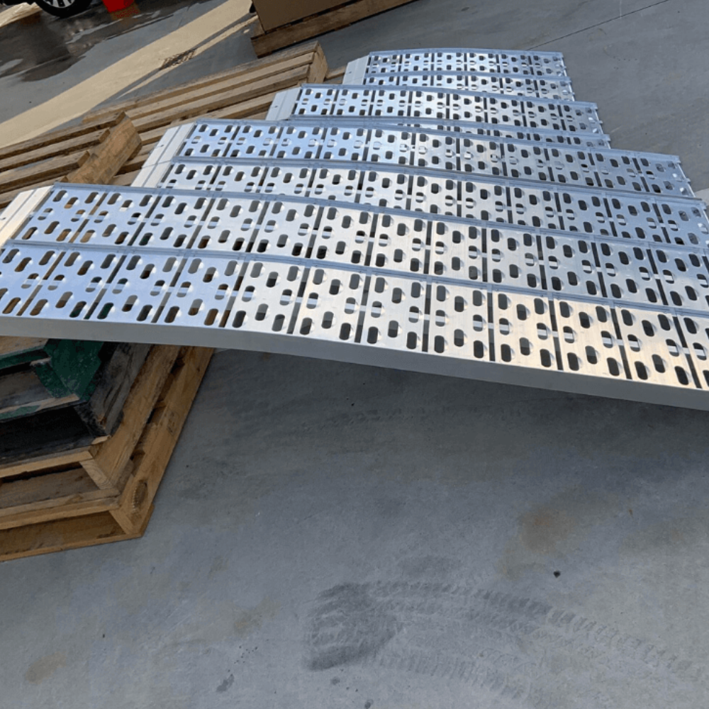 Four different-sized aluminium curved ramps displayed side by side on concrete.