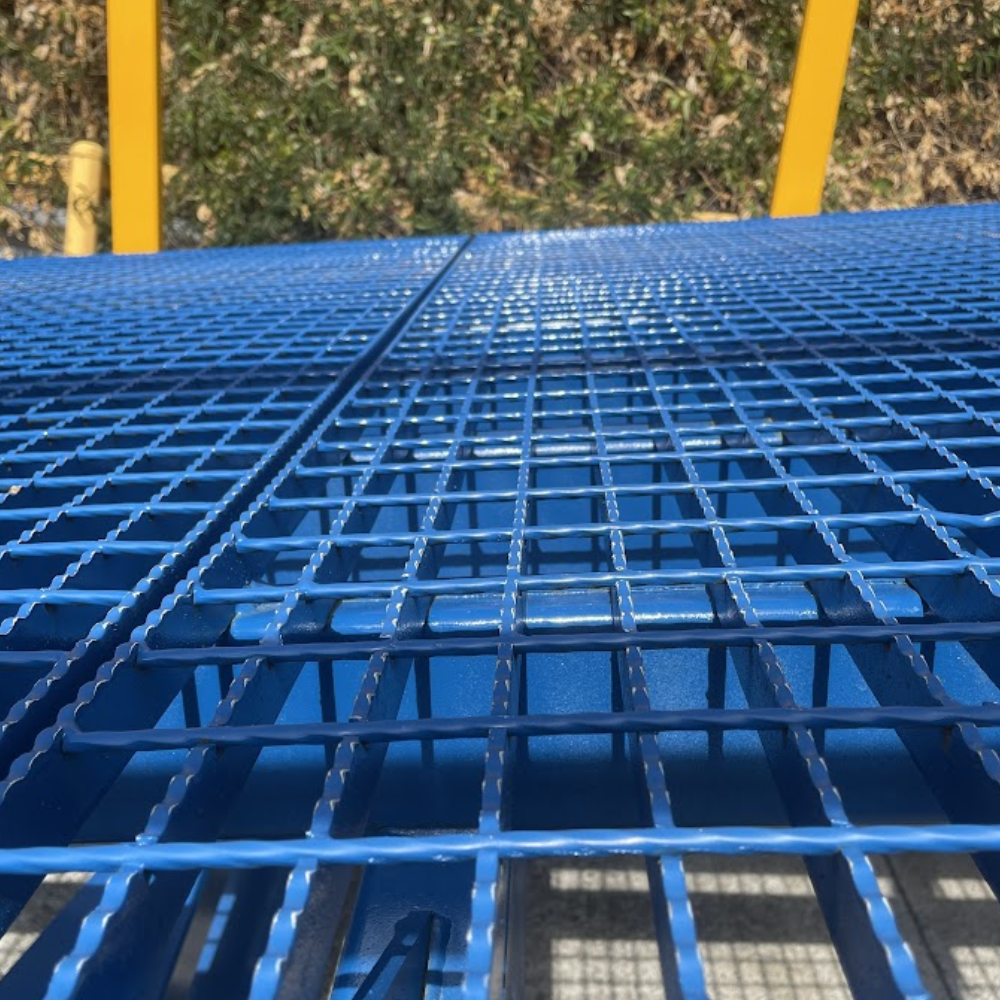 Long view of anti-slip grating surface extending across the ramp.