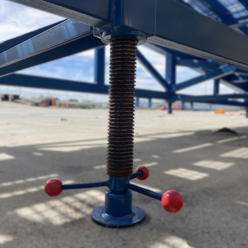 Height-adjustable support leg with threaded spindle and red handles.