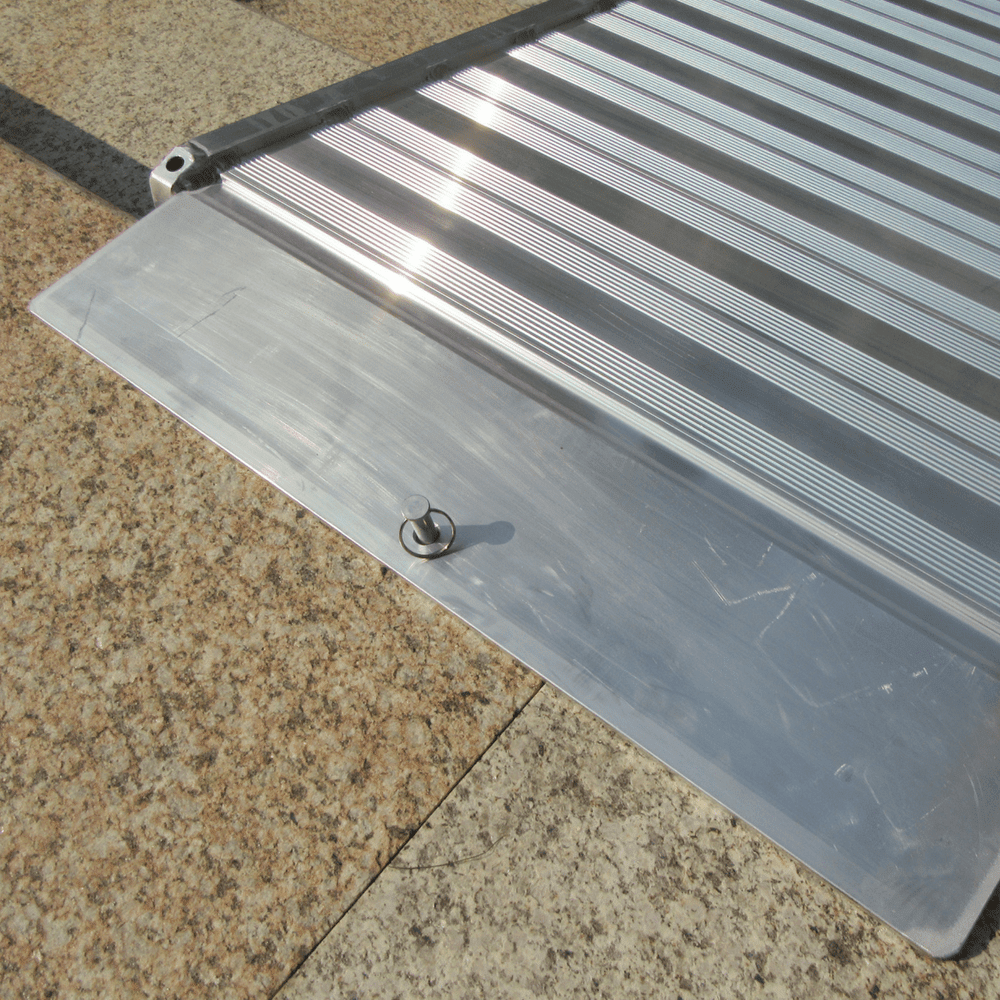 Close-up of textured aluminium ramp surface.