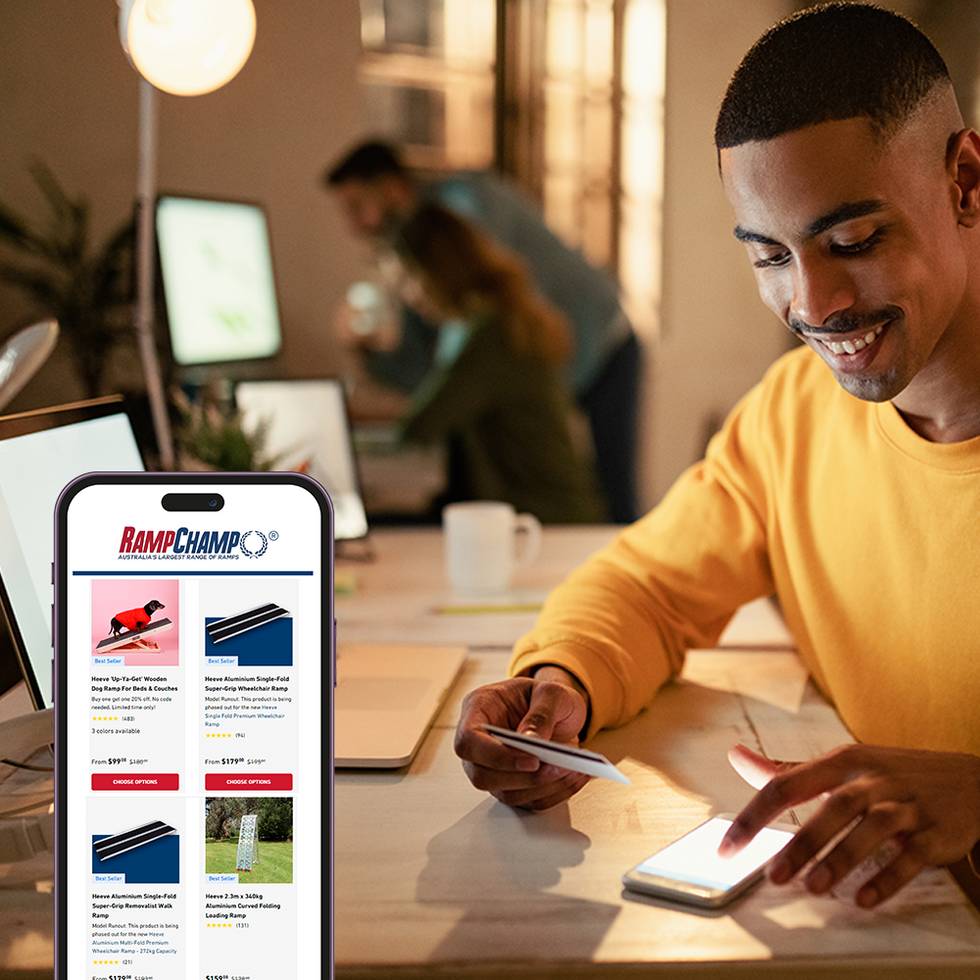 A man in yellow shirt on his computer buying products online from Ramp Champ
