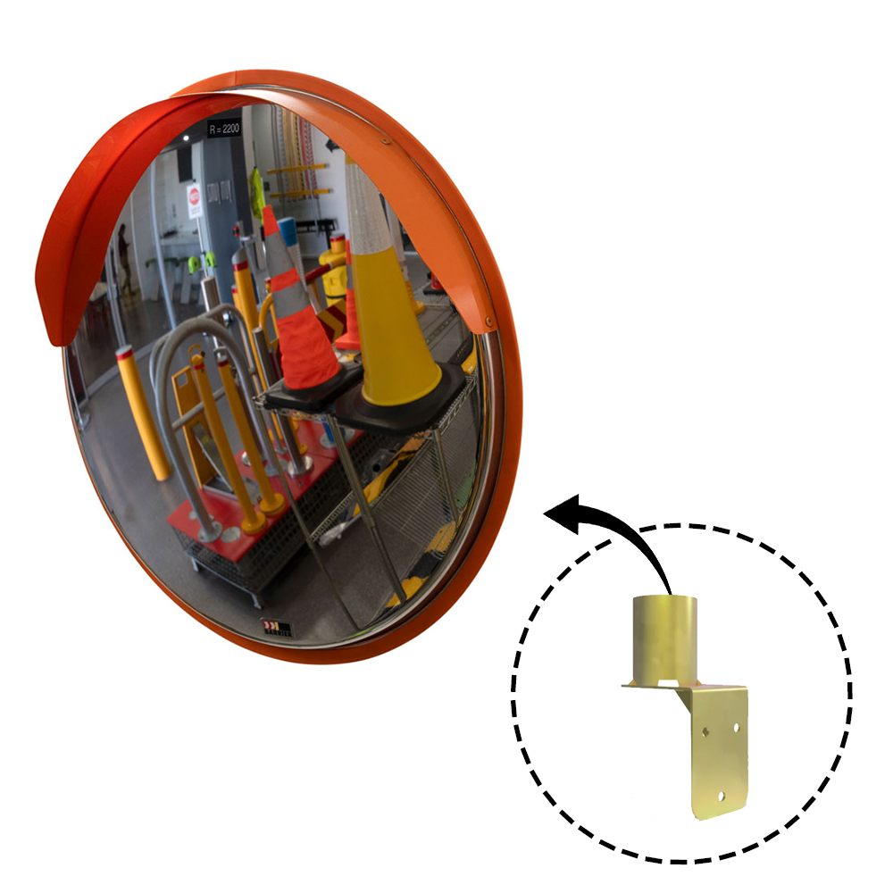 A round convex safety mirror with an orange frame, reflecting an indoor storage area with traffic cones and safety equipment. An inset image highlights the gold-coloured wall mount bracket, indicating its compatibility with the mirror.