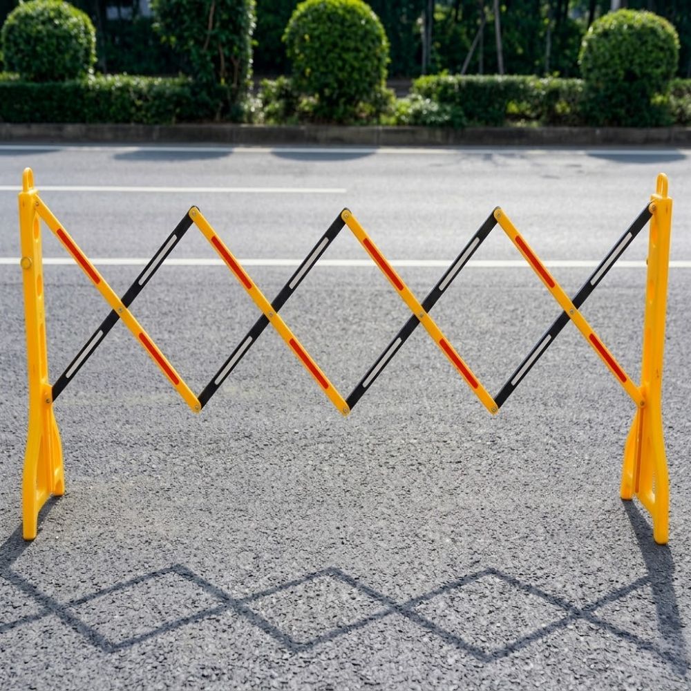 Yellow and black road barrier on a road with green bushes in the background