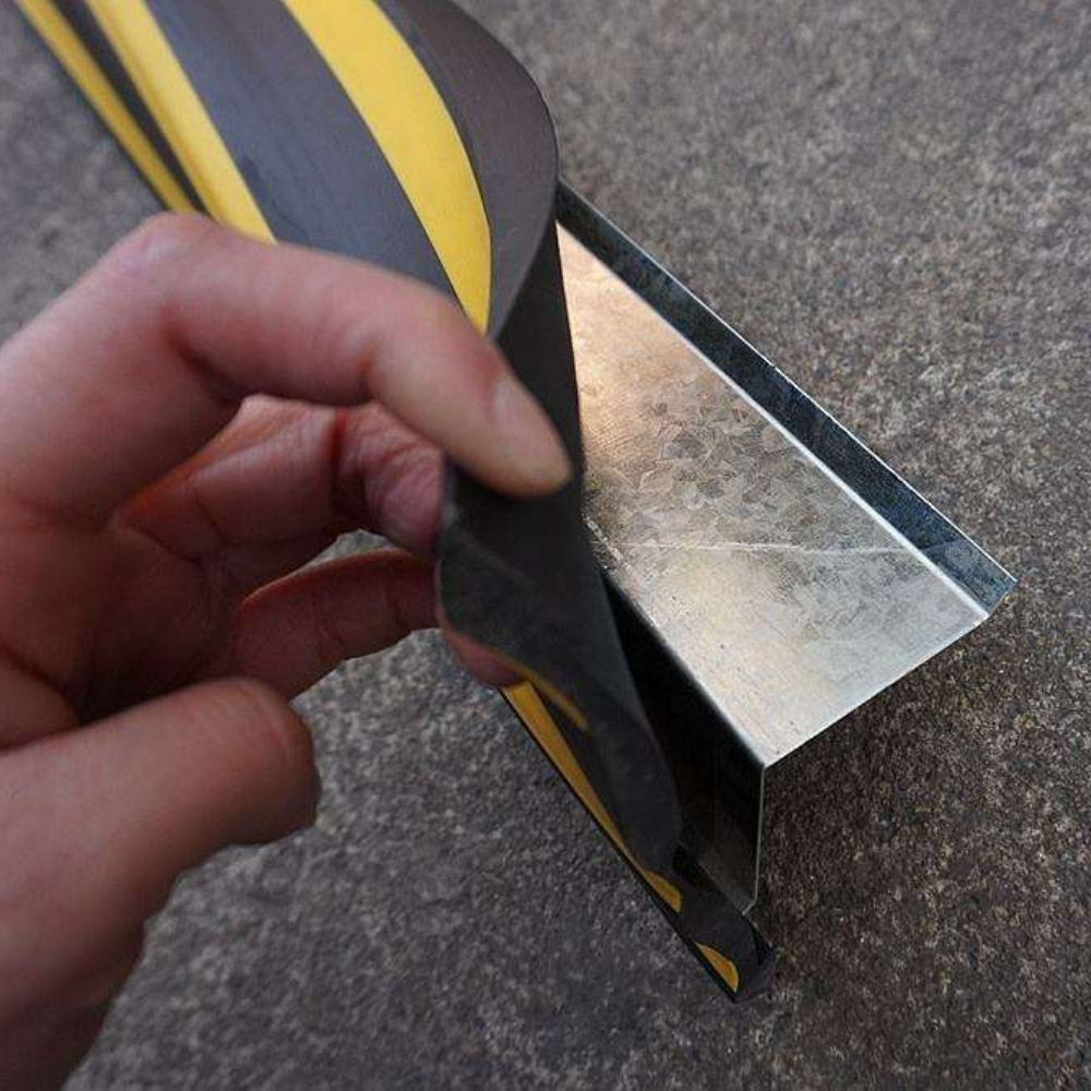 Metal attached to the Base Guard Stainless Steel Reinforced Rubber Corner Guard on concrete surface