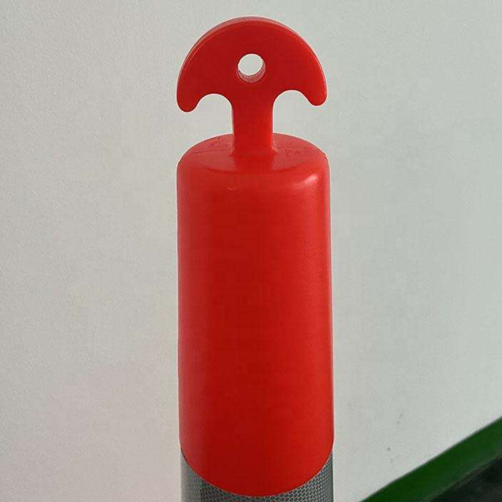 Red plastic cap with a hook on a light gray background