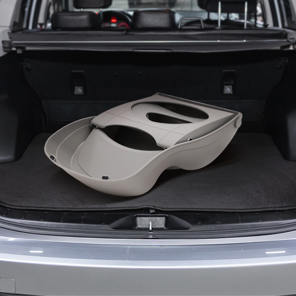Car boot with a beige pet carrier inside