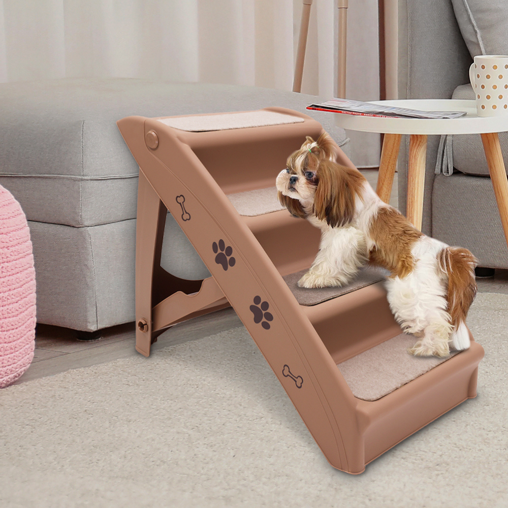 Dog using a set of brown pet steps in a living room.