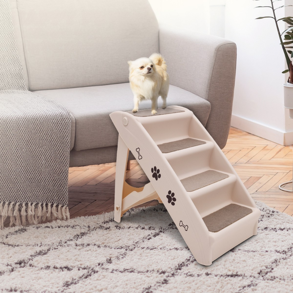 Dog standing on a set of pet stairs in a living room.