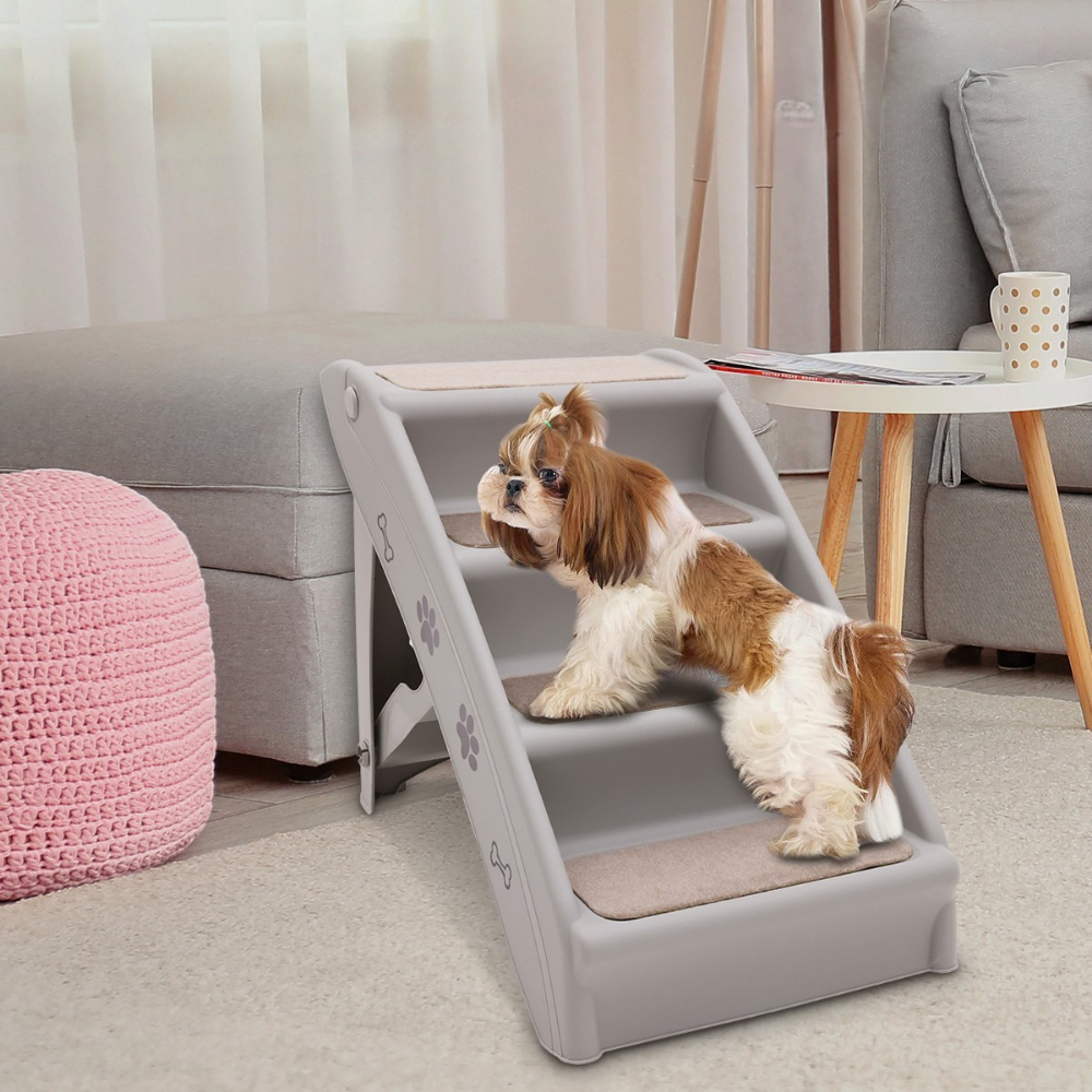 Dog using a set of pet stairs in a living room setting.
