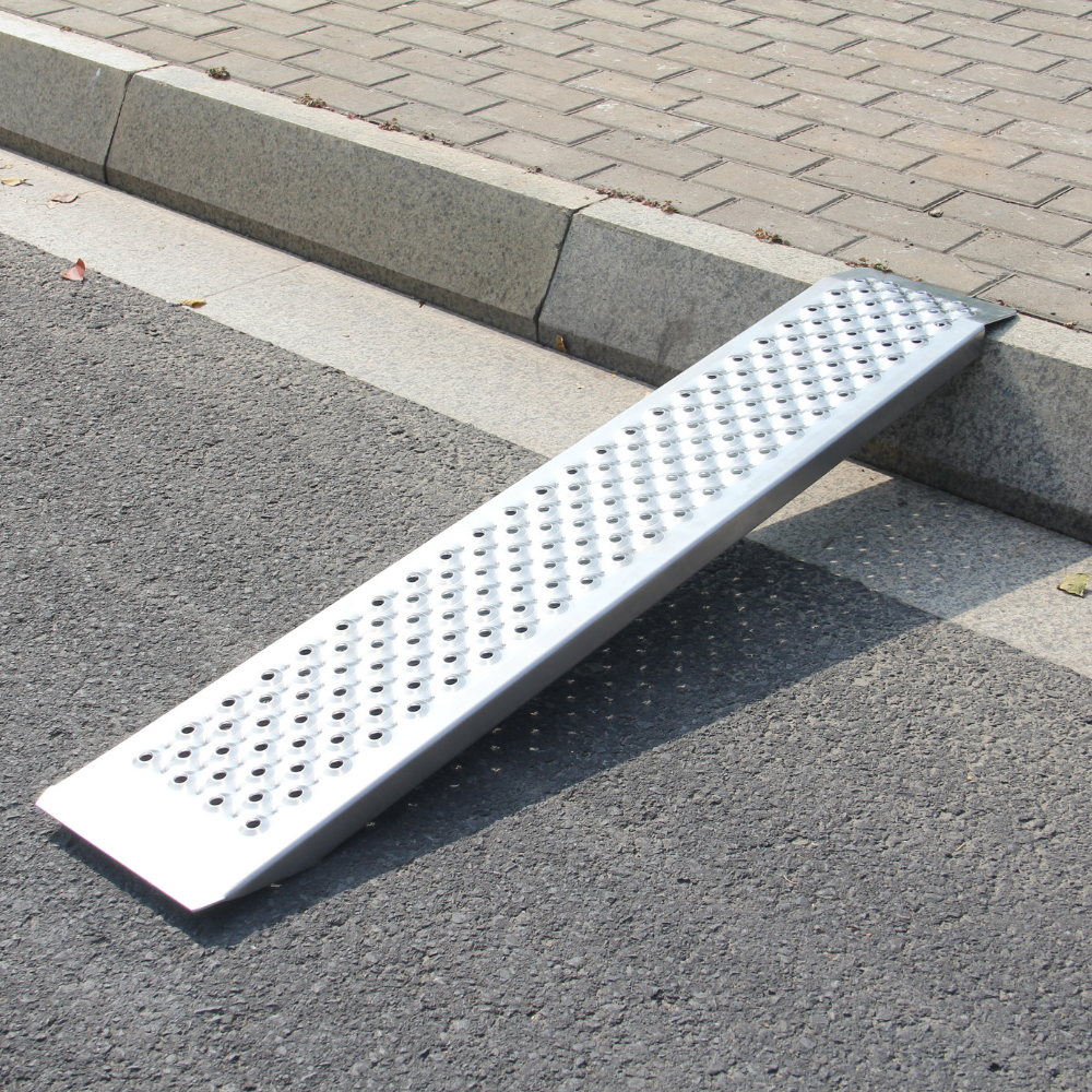 Metal ramp on a paved road next to a curb