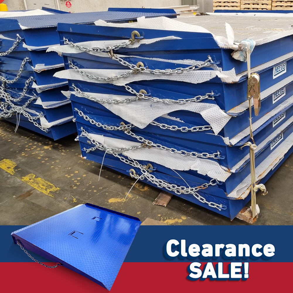 Multiple blue forklift container ramps, tightly stacked with chains securing them, marked with "Clearance Sale!" in the bottom corner.