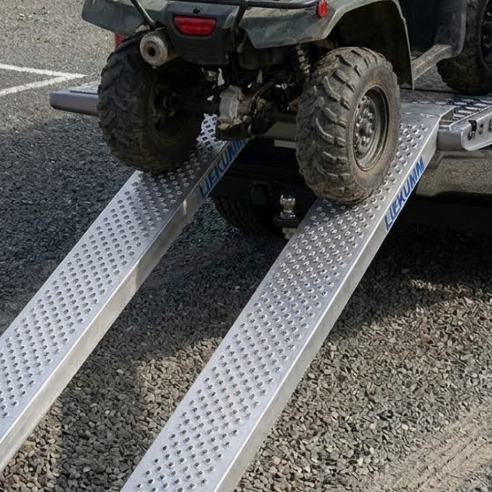 ATV being loaded onto a trailer with a ramp