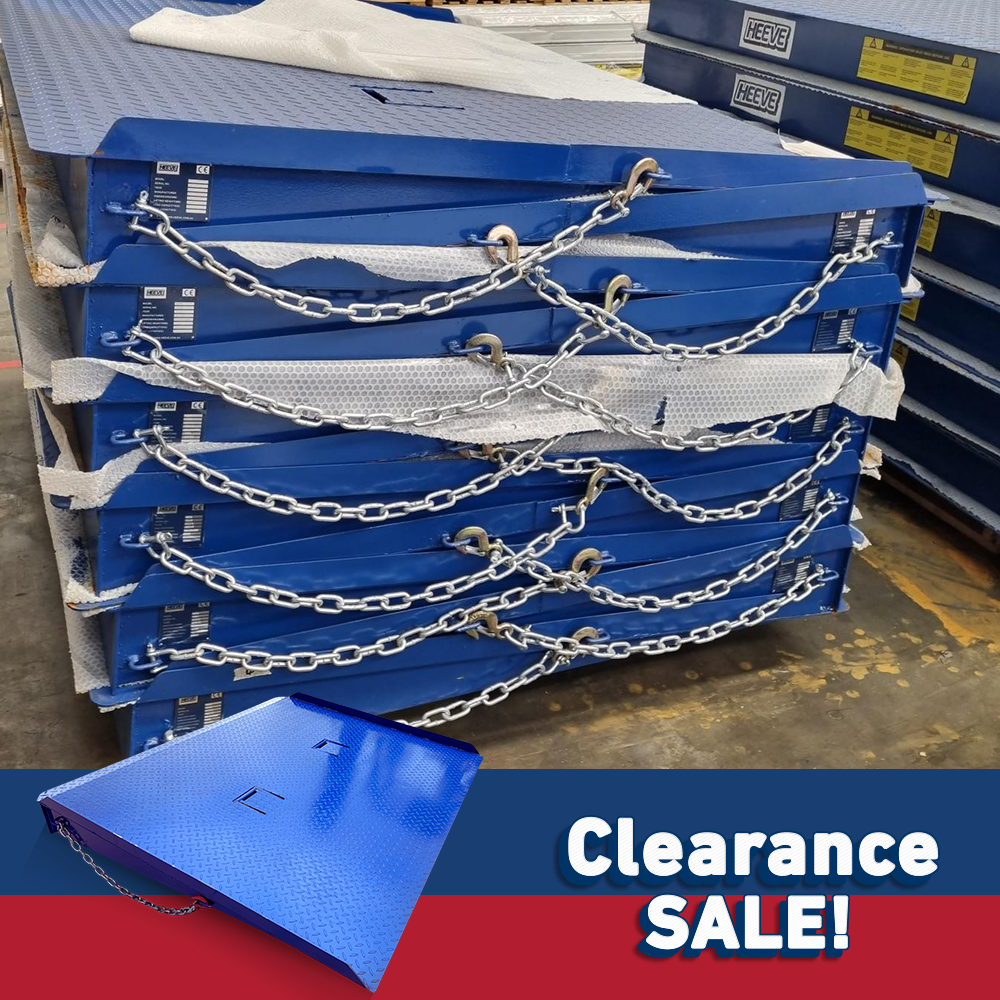 Stack of blue industrial forklift container ramps secured with chains, placed on a warehouse floor, labelled "Clearance Sale!" in the foreground