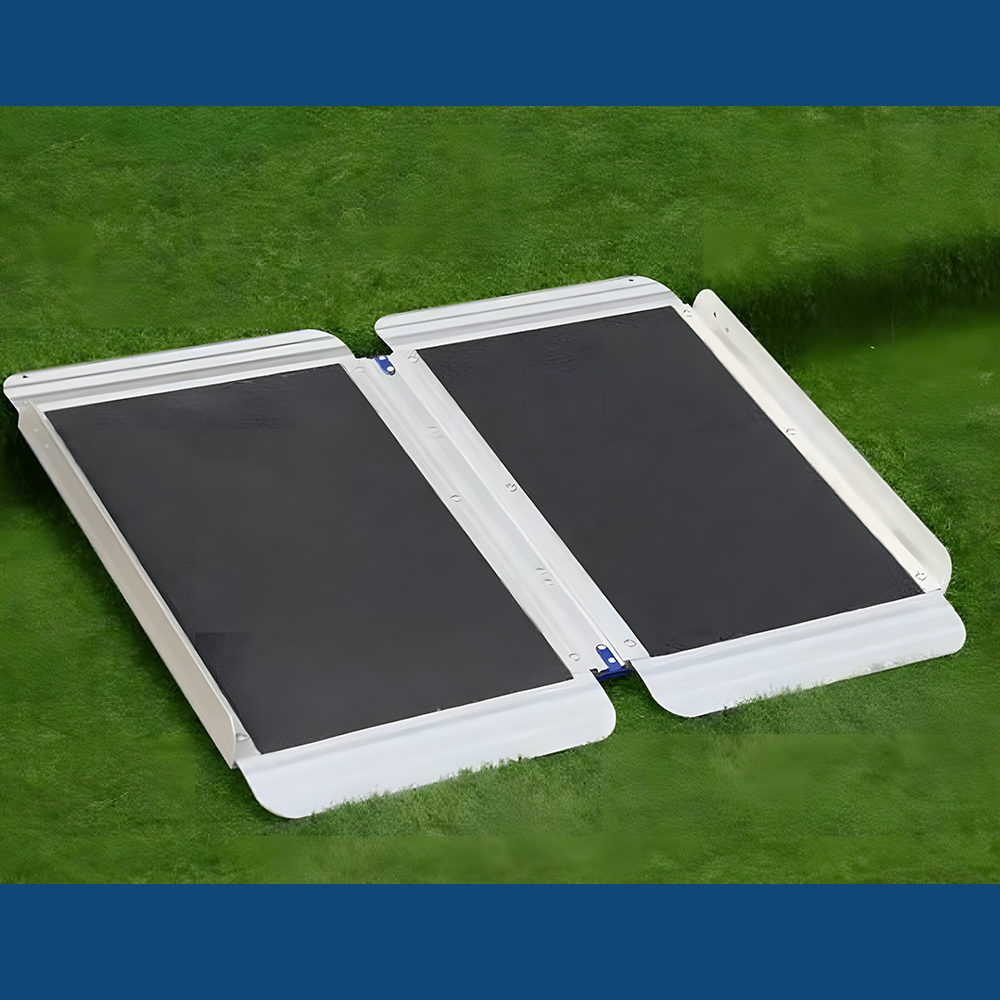 Flat view of Heeve aluminium single-fold mobility ramp on grass, showcasing its skid-resistant surface and sturdy build