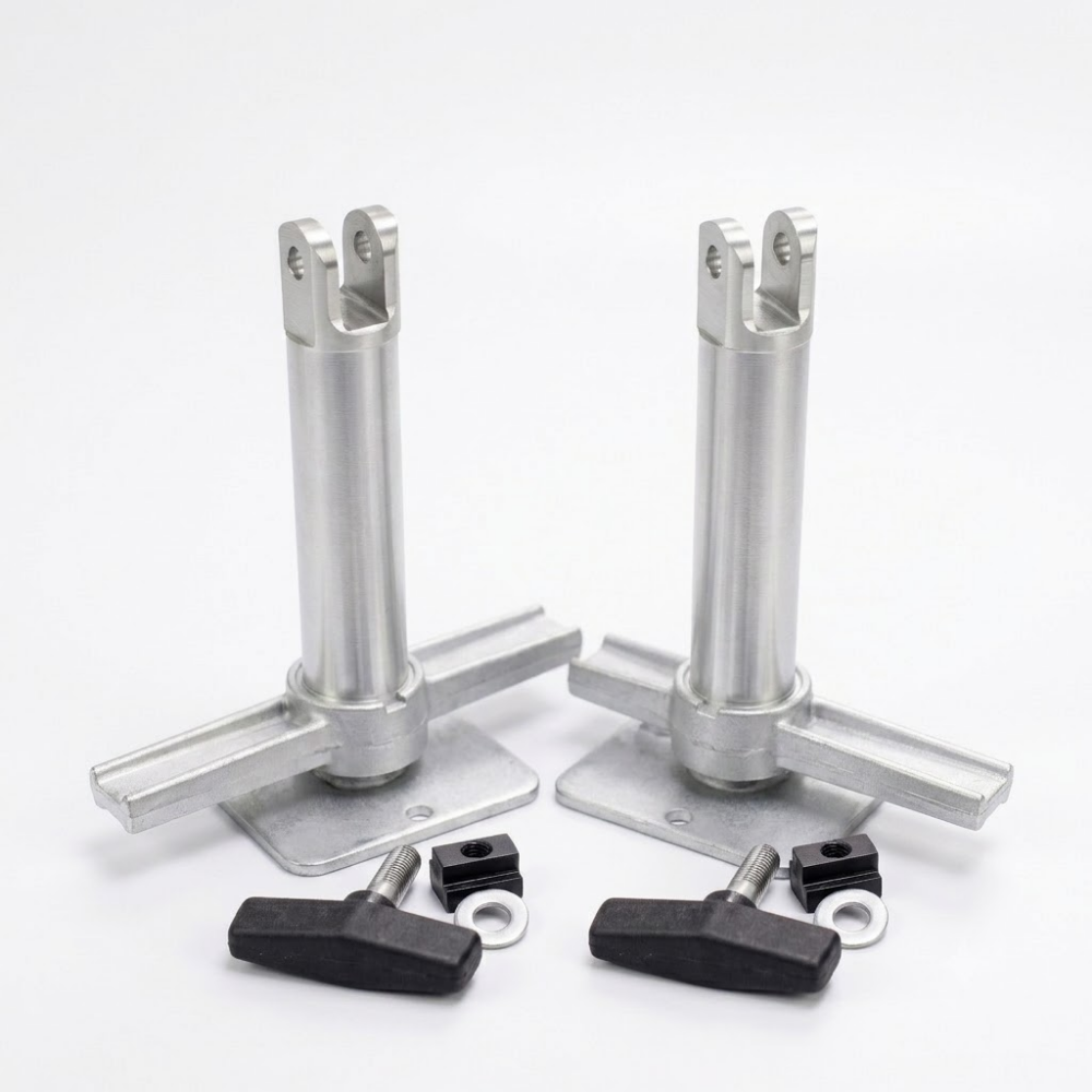 Two silver metal mounting posts with flat base plates, shown with four black wing nuts and small black hardware pieces on a clean white background.