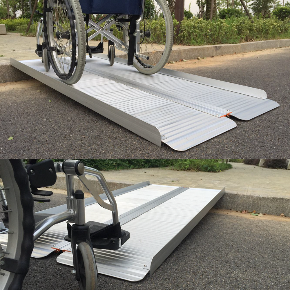 A wheelchair positioned on the Heeve folding aluminium ramp, providing easy access over a small kerb. Full view of the ramp extended on the pavement
