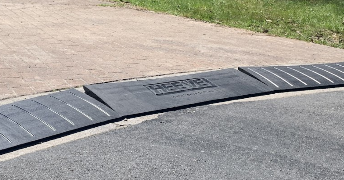 Heave brand name on a set of rubber ramp leading to a driveway.