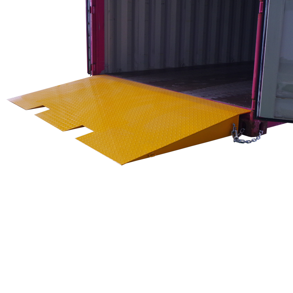 A yellow Heeve self-supporting forklift container ramp placed in front of an open shipping container, showing the forklift tyne slots and the anti-skid surface.