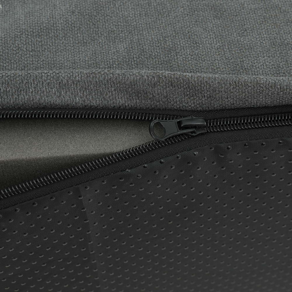 Close-up of a zipper on a gray and black textured foam cover