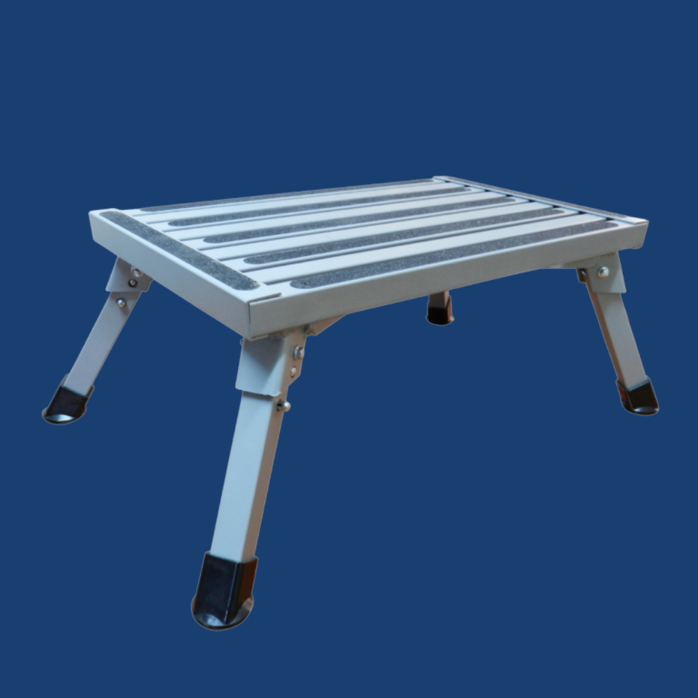 Foldable metal step stool on a blue background