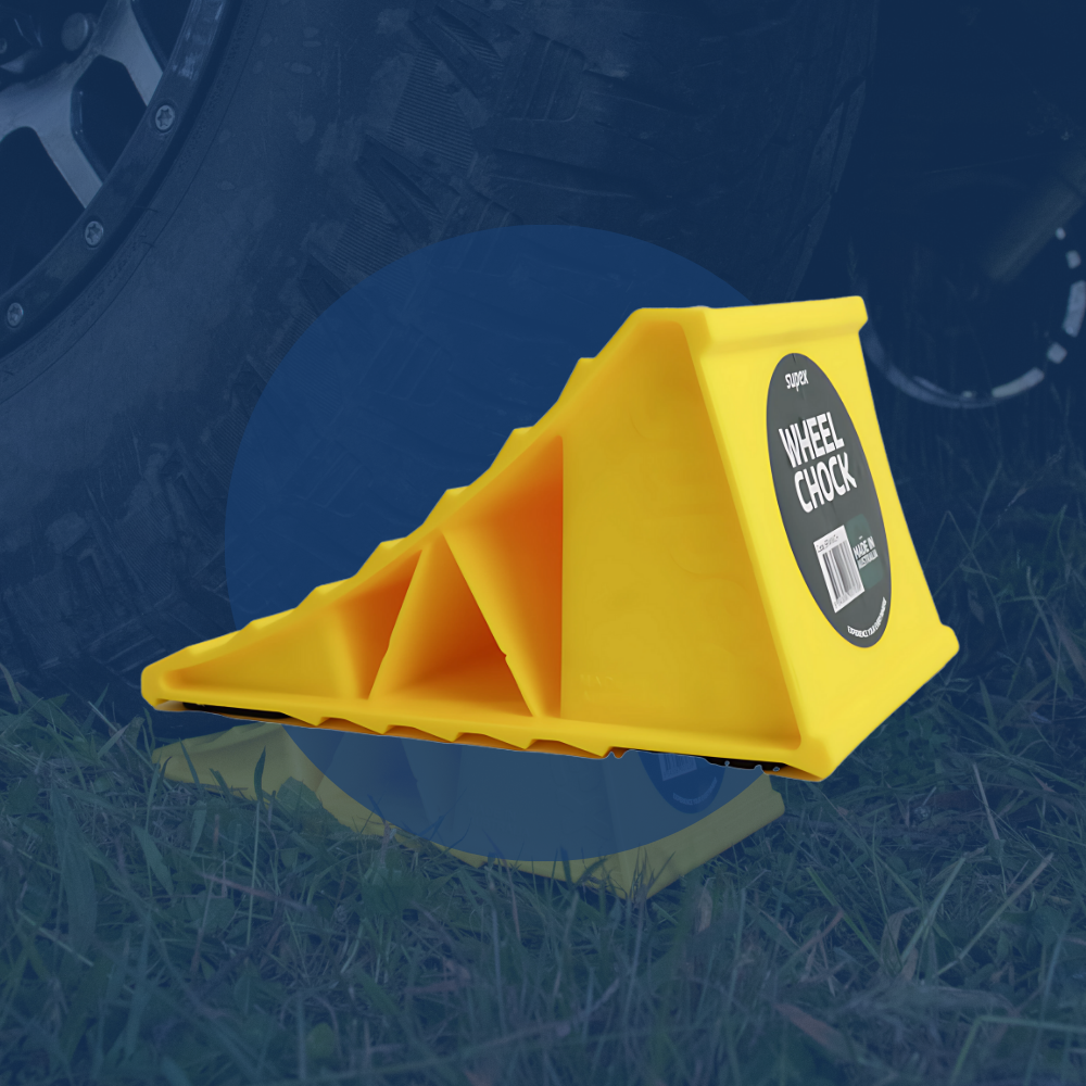 Yellow wheel chock with a label on a grassy background