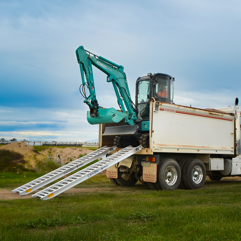 excavator on the rear of the truck descending