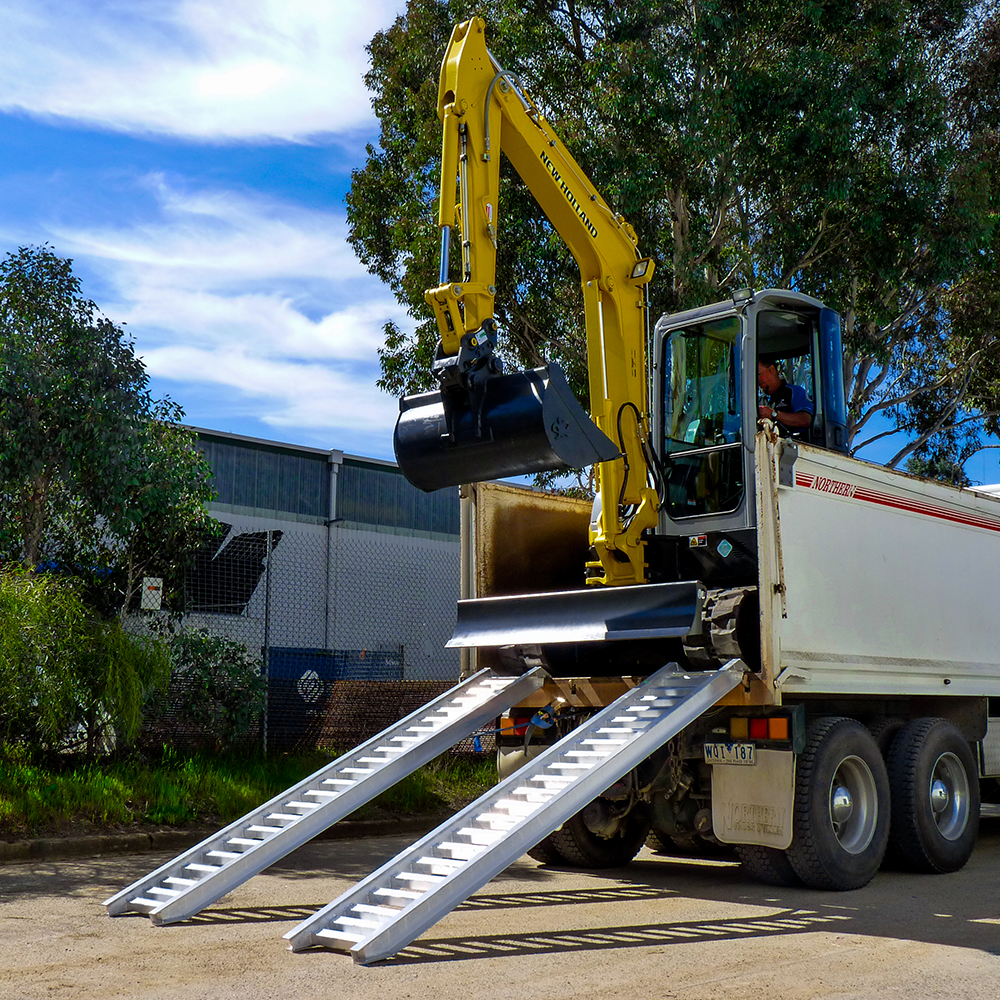 excavator on the rear of the truck descending