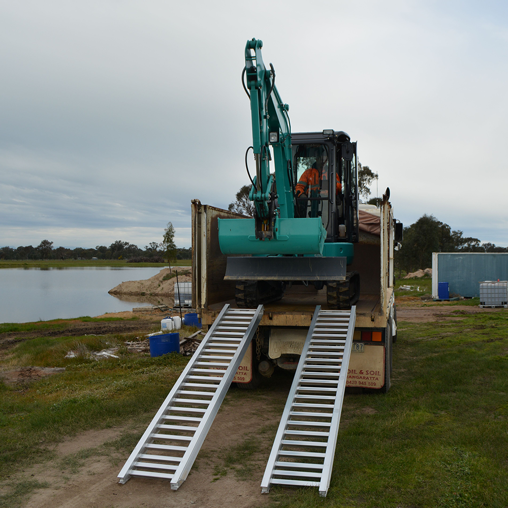 excavator on the rear of the truck descending