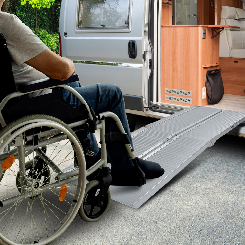 Person in a wheelchair using the ramp to enter a home, demonstrating indoor accessibility.
