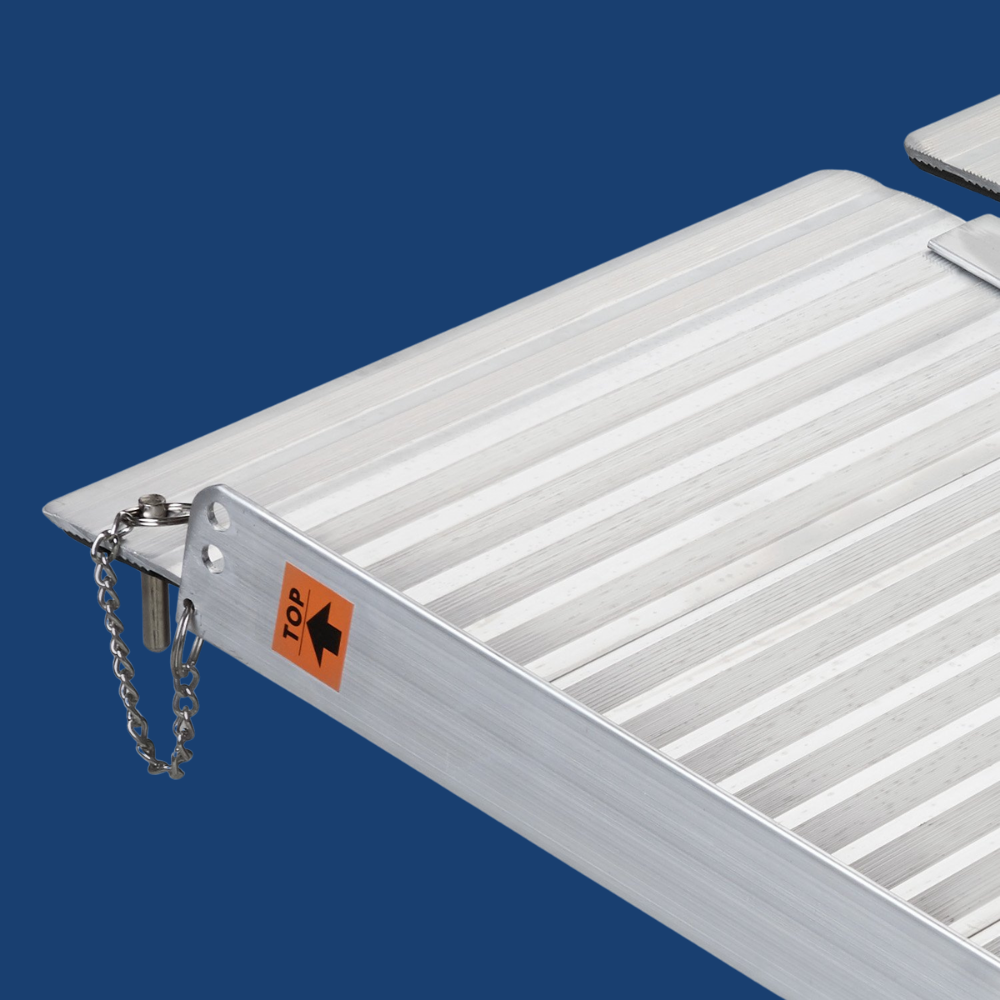 Top corner detail of the ramp’s edge guard and chain connector, shown on a blue background.