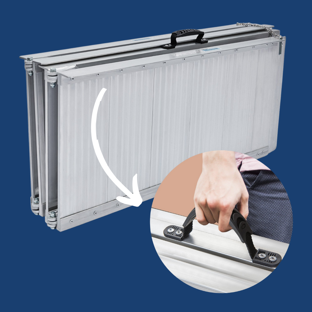 Ramp being folded by hand, showing lightweight design and carry handle.