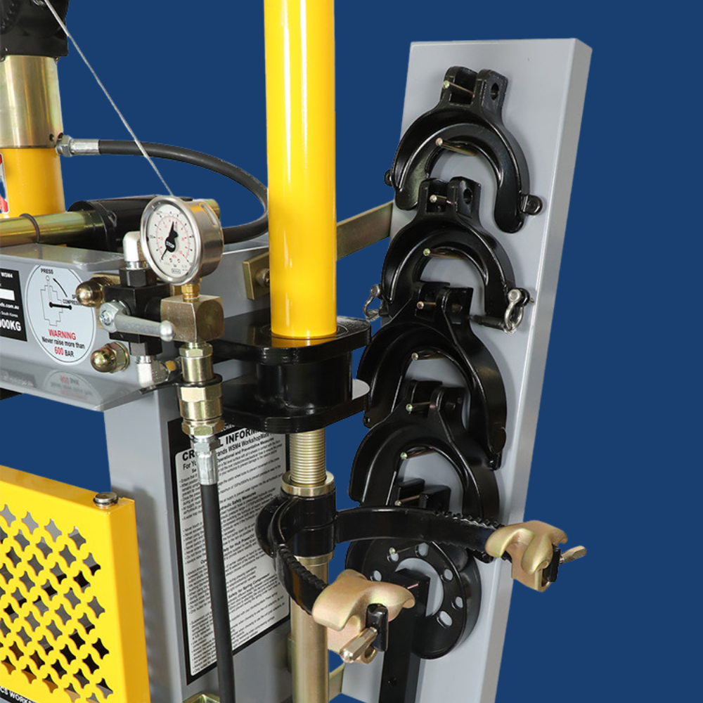 Close-up of storage compartments containing various crimping dies for different applications.