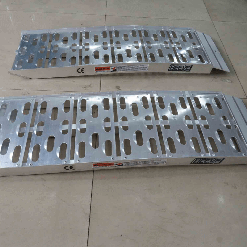 Two curved ramps laid flat on concrete with visible shadows and details.