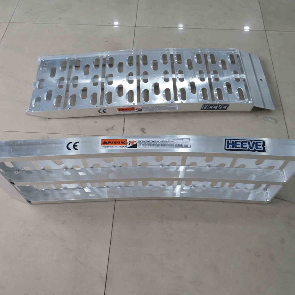 Two curved ramps laid flat on concrete with visible shadows and details.