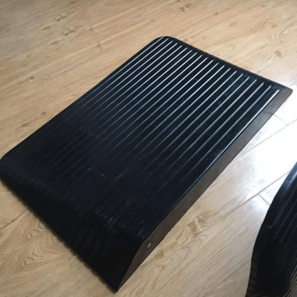 black rubber ramp on wooden planks