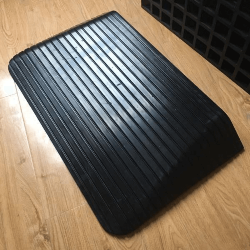 black rubber ramp on wooden planks